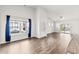 Bright living area with hardwood floors, a large window, and a sliding glass door at 1586 Jardine Loop, Little River, SC 29566