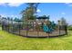 Community playground with various play structures surrounded by a black metal fence at 1586 Jardine Loop, Little River, SC 29566
