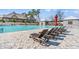 Community pool featuring lounge chairs and umbrellas near the pool's edge at 1586 Jardine Loop, Little River, SC 29566