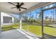 Screened-in porch with fan, overlooking a green lawn and fenced yard at 1586 Jardine Loop, Little River, SC 29566