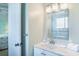 Bathroom with modern vanity, framed mirror, and view of the tiled shower at 162 Norris Dr., Pawleys Island, SC 29585