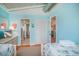Comfortable bedroom with two beds, blue walls, and two doorways for easy access at 162 Norris Dr., Pawleys Island, SC 29585