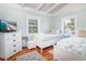 Well-lit bedroom featuring hardwood floors, dresser with TV, and two cozy twin beds at 162 Norris Dr., Pawleys Island, SC 29585
