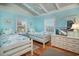 Bright bedroom with two twin beds, matching nightstands, and television on dresser at 162 Norris Dr., Pawleys Island, SC 29585