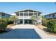 Charming coastal home with a screened porch, covered parking, and a well-maintained gravel driveway at 162 Norris Dr., Pawleys Island, SC 29585