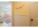 Bright hallway view leading to a bedroom featuring a twin bed with coastal accents at 162 Norris Dr., Pawleys Island, SC 29585