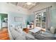 Bright living area with hardwood floors, coastal accents, a comfortable couch, and a view of the porch at 162 Norris Dr., Pawleys Island, SC 29585