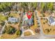 Aerial view of property showcasing the home's layout, landscaping, and location within a wooded neighborhood at 182 Duck Blind Trail, Myrtle Beach, SC 29588