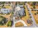 Expansive aerial view of the property showcasing the home, guest house, circular driveway, and lush surroundings at 182 Duck Blind Trail, Myrtle Beach, SC 29588