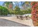 Serene backyard showcasing a stone patio, firepit, elegant seating, and beautiful landscaping at 182 Duck Blind Trail, Myrtle Beach, SC 29588
