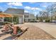 A beautifully designed backyard featuring lounge chairs, an outdoor umbrella, and elegant landscaping on a sunny day at 182 Duck Blind Trail, Myrtle Beach, SC 29588