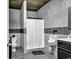 Unique bathroom featuring gray tiled walls, a urinal, and a toilet for a distinctive and functional space at 182 Duck Blind Trail, Myrtle Beach, SC 29588