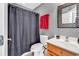 Cozy bathroom features a shower with curtain, decorative mirror, and single sink vanity at 182 Duck Blind Trail, Myrtle Beach, SC 29588