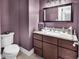 Stylish powder room with granite countertop, contemporary sink, and modern fixtures with a purple wall at 182 Duck Blind Trail, Myrtle Beach, SC 29588