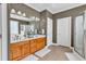 Bathroom featuring double sinks, a walk-in shower, and lots of cabinet space for storage and linens at 182 Duck Blind Trail, Myrtle Beach, SC 29588