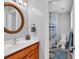 Charming bathroom showcasing a wood vanity, decorative mirror, and a shower with patterned curtain at 182 Duck Blind Trail, Myrtle Beach, SC 29588