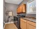 This laundry room includes a washer and dryer, cabinets, and shelving for ample storage, as well as a window at 182 Duck Blind Trail, Myrtle Beach, SC 29588