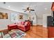 Charming living area with hardwood floors, a modern sectional sofa, and an adjacent kitchen with stainless steel appliances at 182 Duck Blind Trail, Myrtle Beach, SC 29588