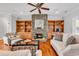 Inviting living room with a floor-to-ceiling stone fireplace, built-in shelving, and hardwood floors at 182 Duck Blind Trail, Myrtle Beach, SC 29588