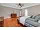 Spacious main bedroom with hardwood floors, tray ceiling, ceiling fan, and a cozy bed with soft linens at 182 Duck Blind Trail, Myrtle Beach, SC 29588