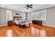 This main bedroom features hardwood floors, a ceiling fan, natural light, and is decorated with neutral colors at 182 Duck Blind Trail, Myrtle Beach, SC 29588