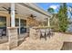 Inviting outdoor kitchen featuring a stone countertop, bar seating, and outdoor ceiling fans at 182 Duck Blind Trail, Myrtle Beach, SC 29588