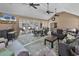 Bright sunroom with multiple ceiling fans, ample seating, and a dining area, perfect for relaxation and entertainment at 182 Duck Blind Trail, Myrtle Beach, SC 29588