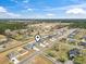 An aerial view of a residential area with modern homes, paved streets, and green spaces at 211 Copperwood Loop, Conway, SC 29526