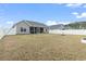 Expansive backyard featuring a white privacy fence, with view of the screened porch and patio at 211 Copperwood Loop, Conway, SC 29526