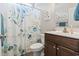 Bathroom featuring a floral shower curtain, toilet, and wood cabinets at 211 Copperwood Loop, Conway, SC 29526