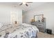 Well-furnished bedroom with a large dresser, a bathroom, and a soft blanket on the bed at 211 Copperwood Loop, Conway, SC 29526