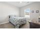 Cozy bedroom with a ceiling fan, window, and patterned bedding, offering a relaxing space at 211 Copperwood Loop, Conway, SC 29526