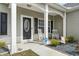 Inviting front porch with rocking chairs, decorative shrubs, and an ADT security system sign at 211 Copperwood Loop, Conway, SC 29526
