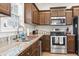 Close up of kitchen featuring stainless steel appliances, granite countertops, and wood-look flooring at 211 Copperwood Loop, Conway, SC 29526
