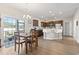 Open kitchen and dining area with wood-look flooring, stainless steel appliances, and backyard access at 211 Copperwood Loop, Conway, SC 29526