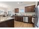 Well-lit kitchen featuring granite countertops, stainless steel appliances, and wood flooring at 211 Copperwood Loop, Conway, SC 29526