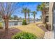 Landscaped backyard with manicured lawn, lush vegetation, and waterfront views at 2180 Waterview Dr. # 713, North Myrtle Beach, SC 29582