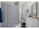 Bathroom featuring walk-in shower with patterned curtain, white vanity, and neutral colors at 2180 Waterview Dr. # 713, North Myrtle Beach, SC 29582