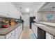 Spacious kitchen with white cabinetry, modern appliances, and tiled backsplash, designed for both style and functionality at 2180 Waterview Dr. # 713, North Myrtle Beach, SC 29582