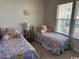 Charming bedroom with two twin beds, butterfly-themed decor and bright natural light at 2441 Capri Court, Conway, SC 29527