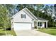 Charming home featuring a two-car garage, neutral siding, and a welcoming front porch at 2441 Capri Court, Conway, SC 29527