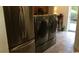 Modern laundry room with stainless steel washer and dryer units, plus a matching refrigerator at 259 19Th Ave. S, Myrtle Beach, SC 29577