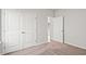 Carpeted bedroom featuring double doors to closet and passage way at 261 Six Mile Creek Dr., Georgetown, SC 29440