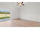 Bright bedroom featuring high ceilings, wood floors, and sliding glass doors leading to the outdoors at 261 Six Mile Creek Dr., Georgetown, SC 29440