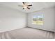 Bright bedroom with neutral carpet, ceiling fan, and window overlooking trees at 261 Six Mile Creek Dr., Georgetown, SC 29440