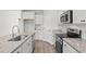 This contemporary kitchen features granite countertops, stainless appliances, and white cabinets at 261 Six Mile Creek Dr., Georgetown, SC 29440
