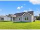 Grey home with a covered patio overlooking the large green yard, perfect for outdoor activities and relaxation at 261 Six Mile Creek Dr., Georgetown, SC 29440