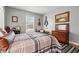 Bedroom with hardwood floors, window and bed with plaid bedding at 3618 Highway 430, Nichols, SC 29581