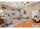 Spacious living room with hardwood floors, multiple seating areas, ceiling fans, and elegant decor at 3618 Highway 430, Nichols, SC 29581