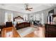 Bright main bedroom with hardwood floors, large windows, ceiling fan, and decorative furniture at 3618 Highway 430, Nichols, SC 29581